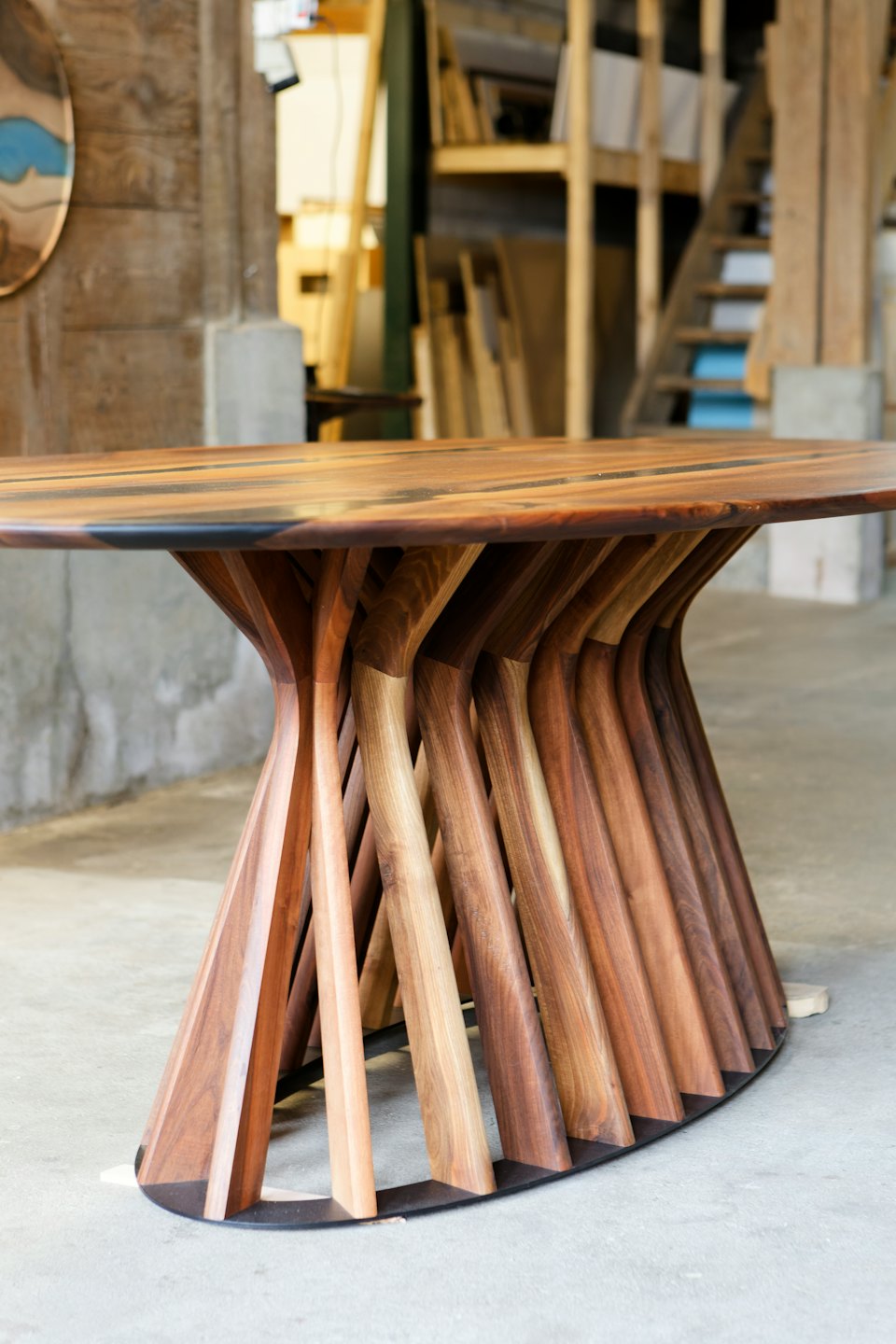 Tavolo scultoreo in legno con base elaborata in studio.